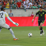 Mexico's Javier Hernandez shoots the ball against Ecuador goalkeepper Alexander Dominguez during the first half of Saturday's game at the Los Angeles Memorial Coliseum.