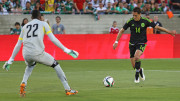 Mexico's Javier Hernandez shoots the ball against Ecuador goalkeepper Alexander Dominguez during the first half of Saturday's game at the Los Angeles Memorial Coliseum.